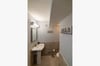 The master bathroom features a walk-in shower and pedestal sink