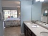 The Main bath has upscale cabinetry and dual sinks for your convenience. This separate dressing area is really nice!