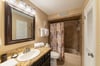The guest bathroom has a tub/shower combo and beautiful granite counter