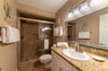 The master bathroom offers a walk-in shower with glass doors and granite counters.