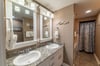 En-suite master bath with double vanities, walk-in shower, and soaking tub