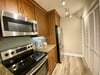 Beautiful modern stainless appliances and beautiful lighting, too.