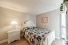 The Coastal Cottage guest bedroom offers a queen sized bed with tropical print bedding