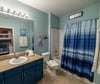 The guest bath features a tub/shower combo and single vanity