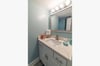 Single vanity with marble top in the bathroom.