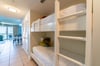 The hallway offers twin over twin bunk beds for the little ones