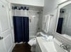 Elegant tiled tub/shower combo in the second bathroom