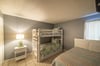 The Coastal Escape guest bedroom offers a bunk bed with trundle and queen sized bed