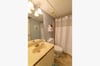 The Blue Seas third bathroom has a single vanity and tub/shower combo