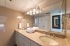 The en-suite bathroom features a large vanity space and soaking tub